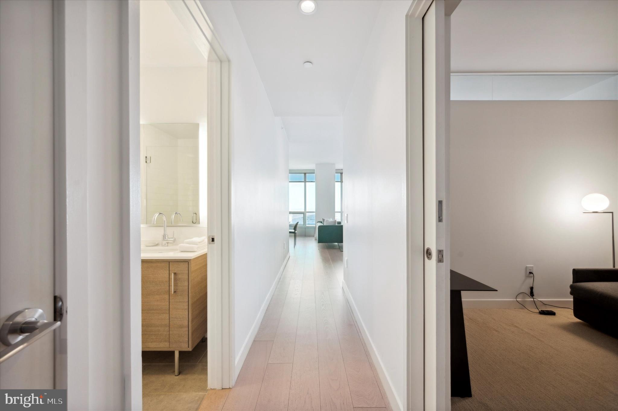 2930 Walnut Street, Unit 3613 Philadelphia, PA 19104 - Photo 20 of 33 a view of a hallway with wooden floor and a bathroom