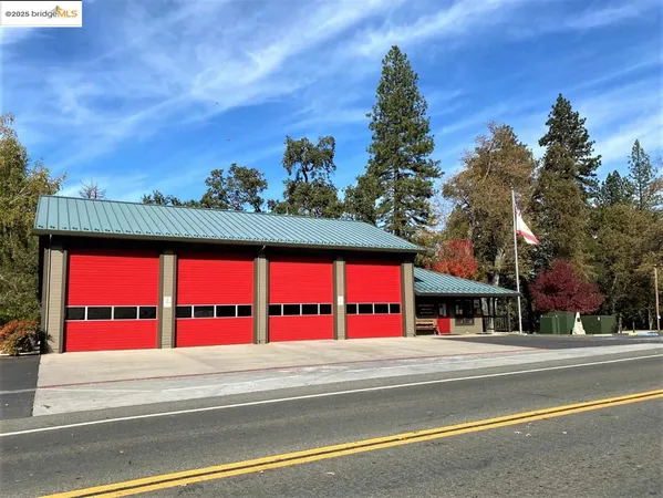 a view of a house with fountain and potted plants
