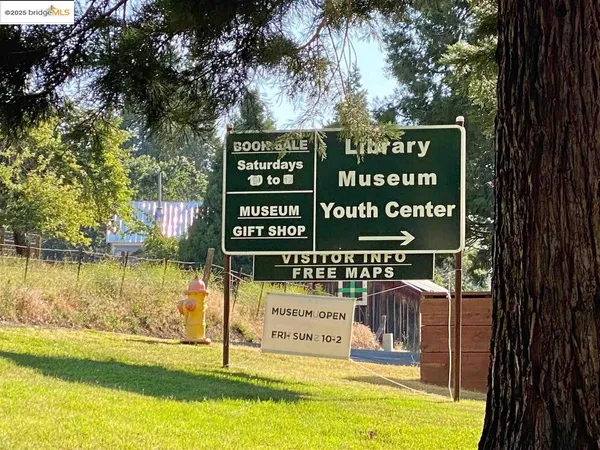 a view of outdoor space with signage and flags