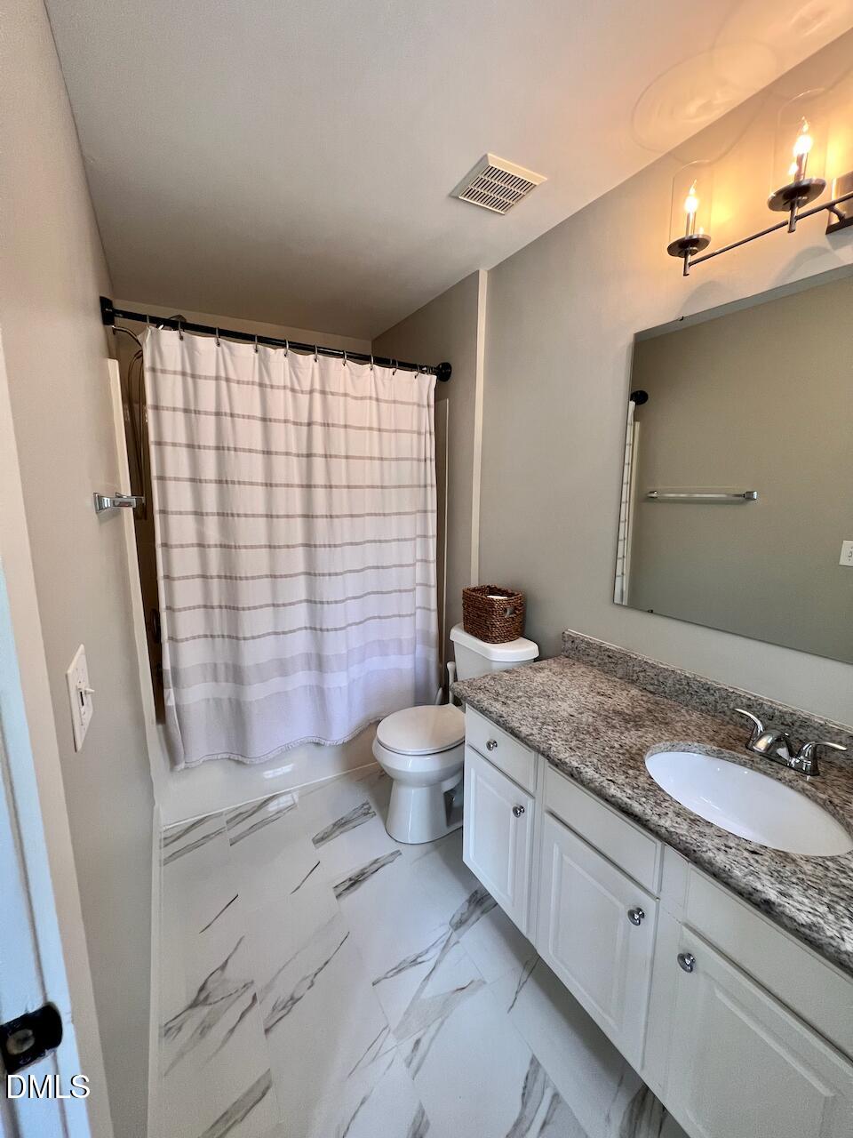 1941 Lost Lane Raleigh, NC 27603 - Photo 18 of 25 a bathroom with a granite countertop sink toilet a mirror and shower