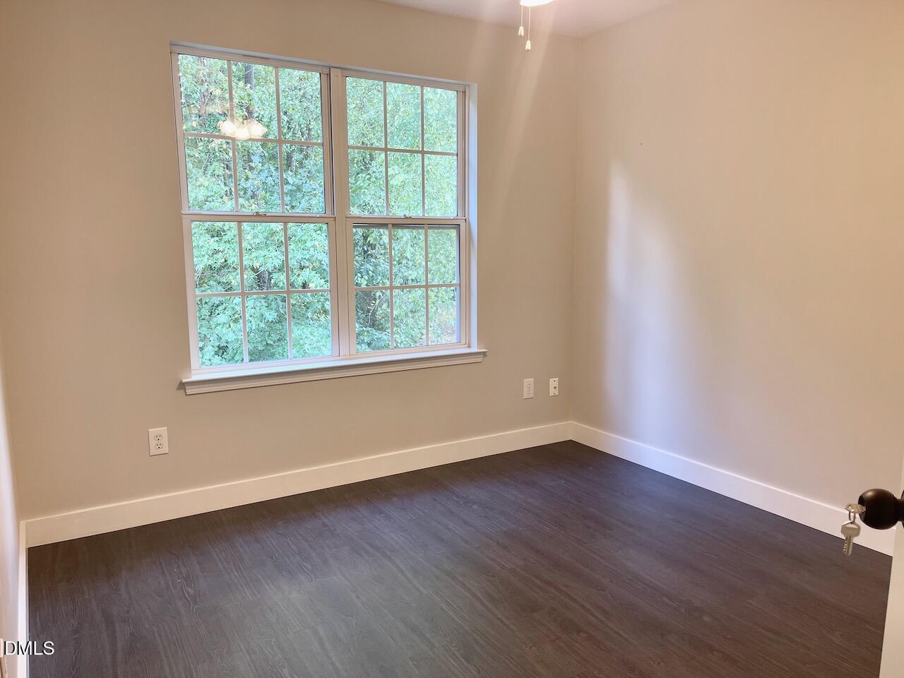 1941 Lost Lane Raleigh, NC 27603 - Photo 20 of 25 an empty room with wooden floor and windows
