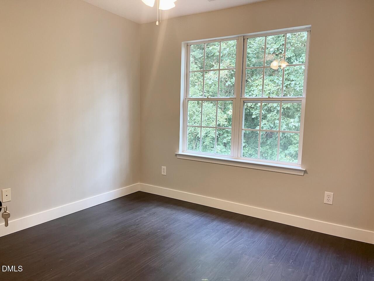 1941 Lost Lane Raleigh, NC 27603 - Photo 22 of 25 an empty room with wooden floor and windows