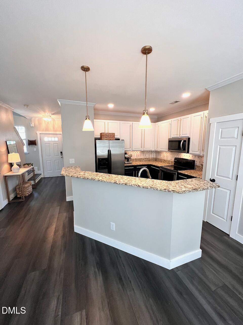 1941 Lost Lane Raleigh, NC 27603 - Photo 10 of 25 a large kitchen with stainless steel appliances granite countertop a stove a sink a refrigerator and a wooden floor