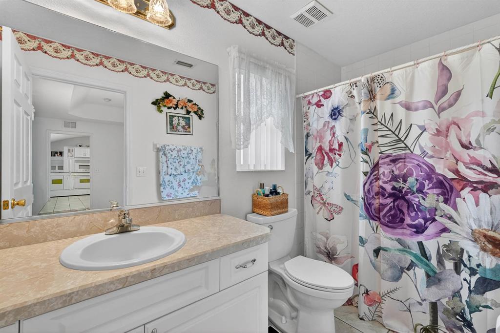 80 Roxboro Drive Palm Coast, FL 32164 - Photo 19 of 39 a bathroom with a toilet sink and mirror