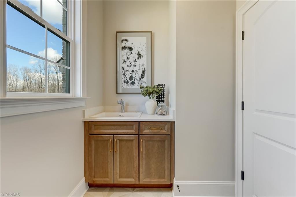 6806 Brennan Way Oak Ridge, NC 27310 - Photo 25 of 50 main level laundry room with sink