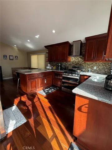 a kitchen with stainless steel appliances granite countertop a stove a sink and a microwave