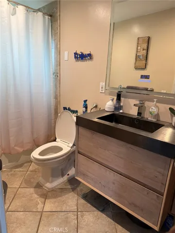 a bathroom with a sink a toilet and mirror