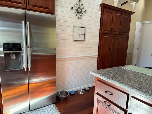a kitchen with a refrigerator and cabinets