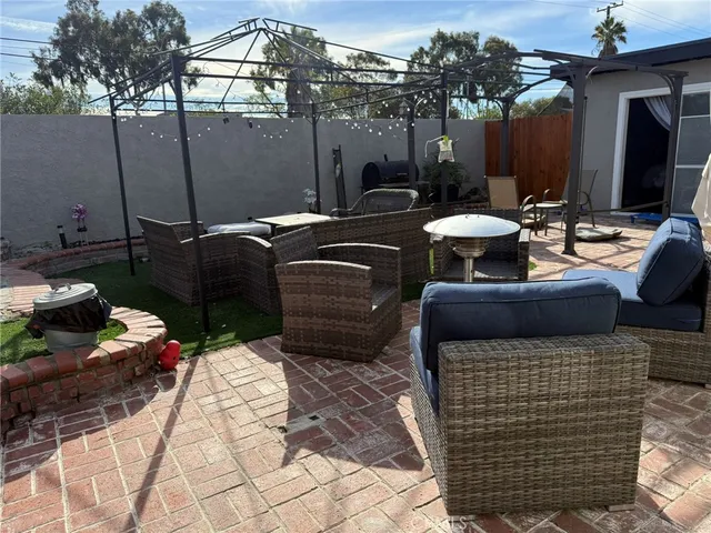 a view of a patio with couches chairs and potted plants