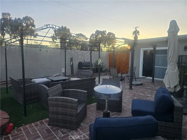 a view of a terrace with couches and a fire pit