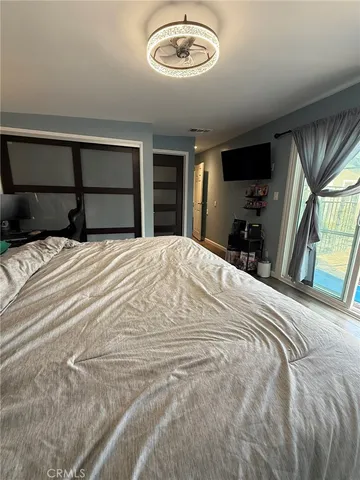 a bedroom with a large bed and a tv