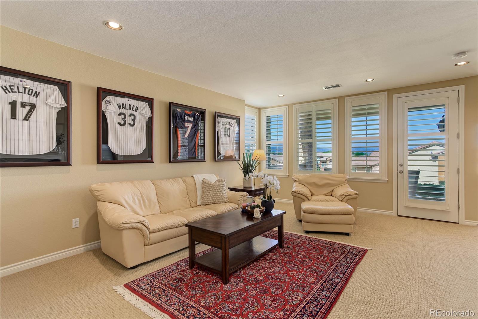 9285 Viaggio Way Highlands Ranch, CO 80126 - Photo 32 of 45 a living room with furniture and large window