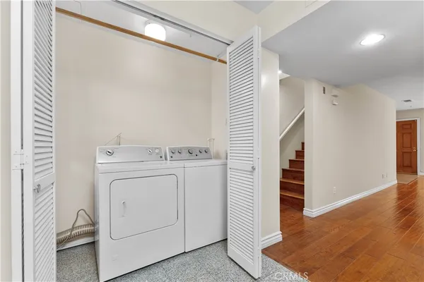 a view of storage and utility room with washer and dryer