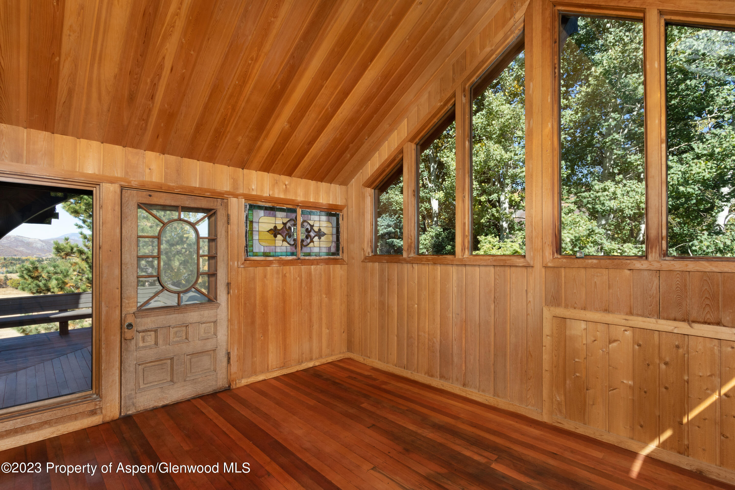 137 Primrose Path Aspen, CO 81611 - Photo 17 of 46 a view of an empty room with wooden floor and a window