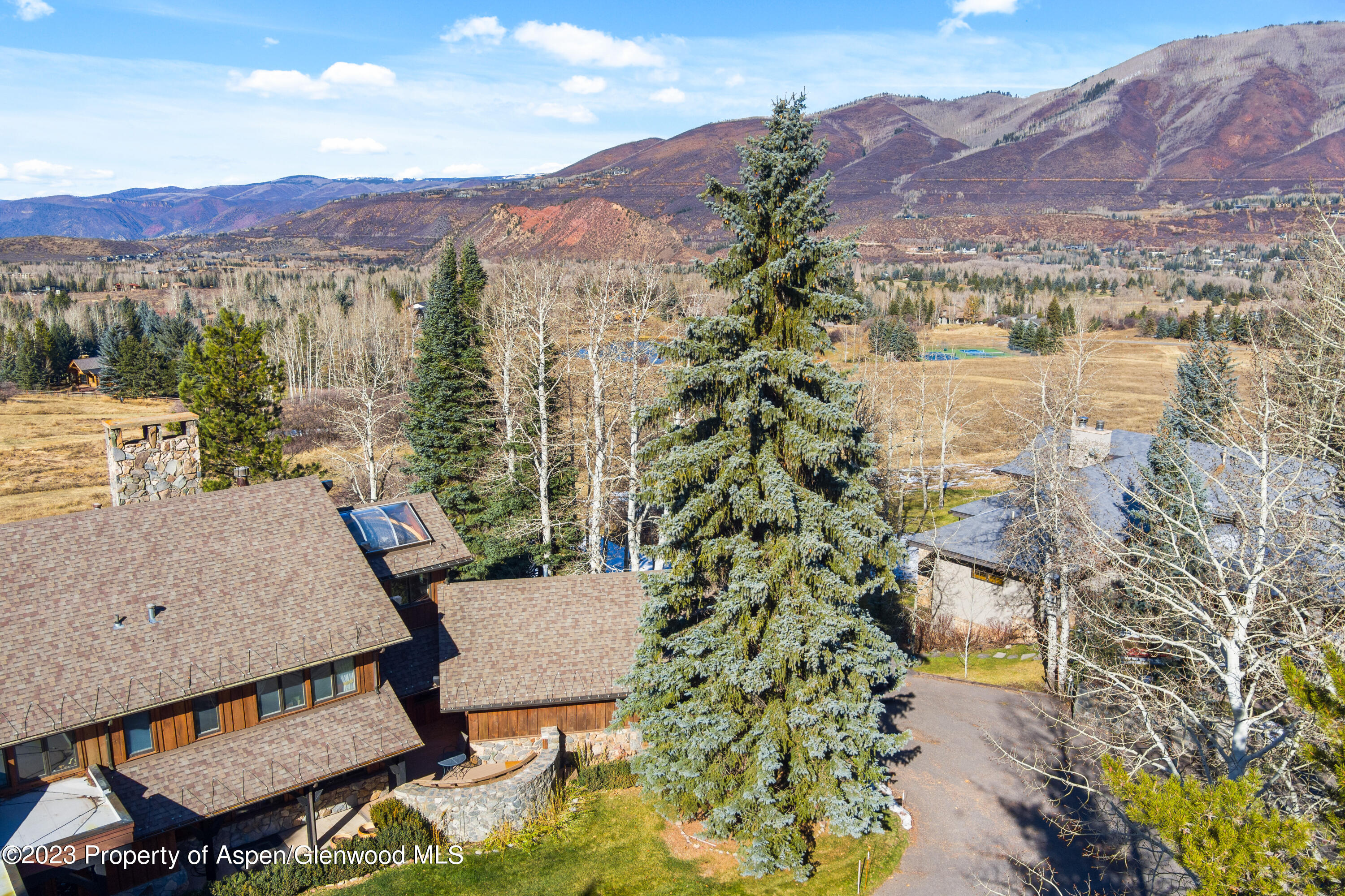 137 Primrose Path Aspen, CO 81611 - Photo 6 of 46 a view of a terrace with a table and chairs under an umbrella
