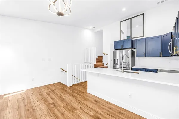 a view of a room with wooden floor
