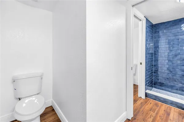 a bathroom with a granite countertop toilet and a sink