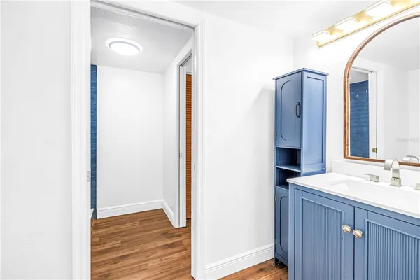 a view of an empty room with wooden floor