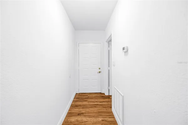 a kitchen with granite countertop a refrigerator stove and microwave