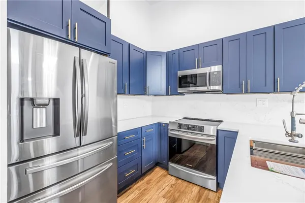 a kitchen with a refrigerator a stove top oven a sink and dishwasher