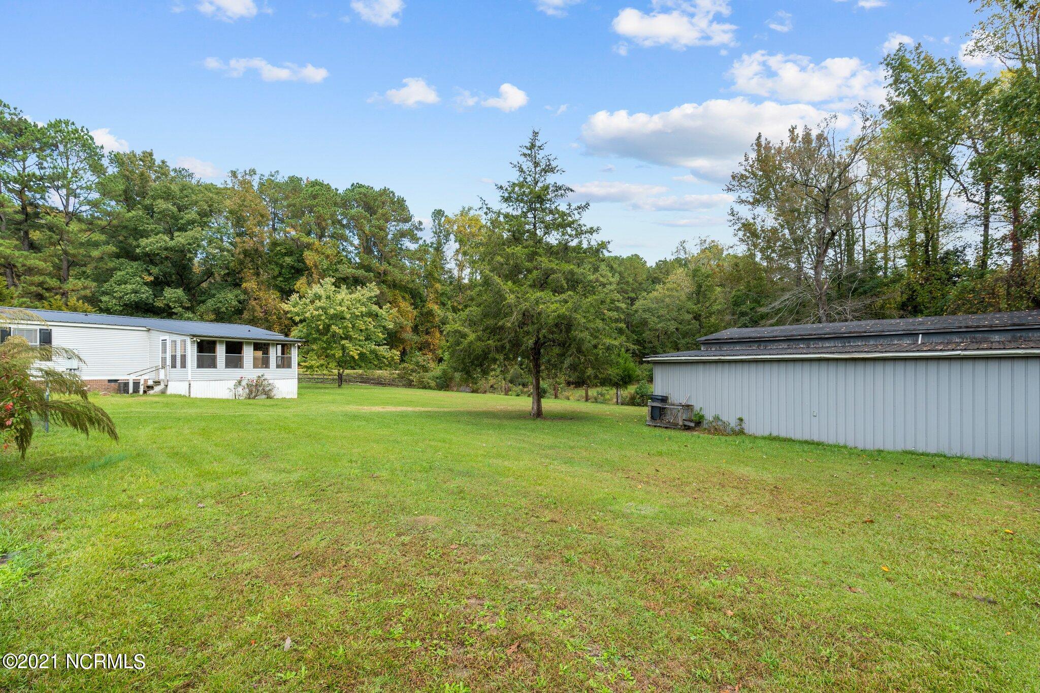 1477 Farm Life School Road Carthage, NC 28327 - Photo 25 of 32 View from back corner of land...you've got a large yard, and a detached garage and workshop. Heaven!