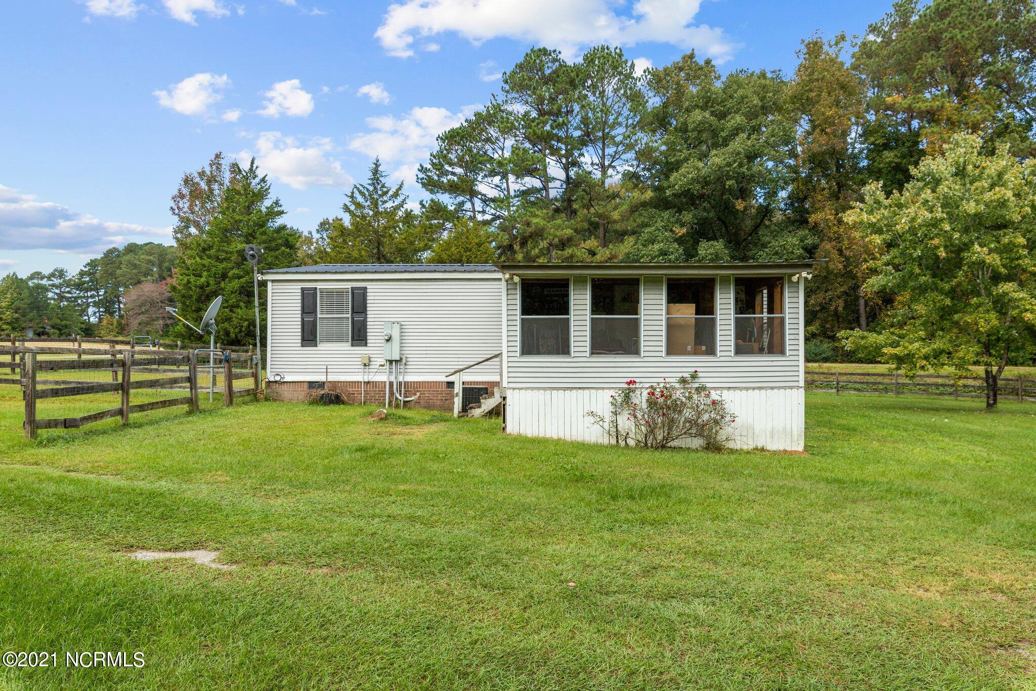 1477 Farm Life School Road Carthage, NC 28327 - Photo 27 of 32 Rear of house showing 3-season porch. Unheated porch is approx. 235 sq ft.