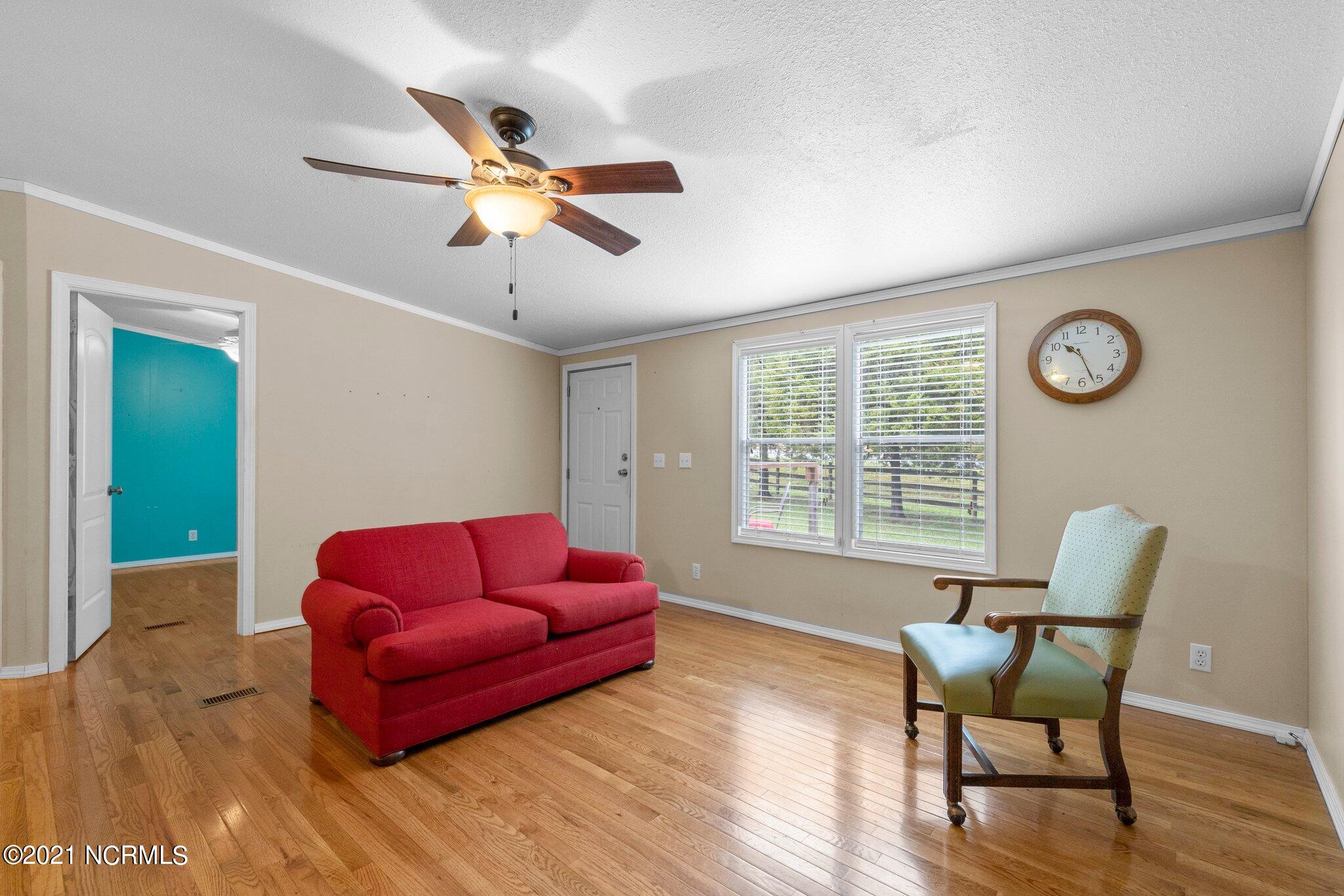 1477 Farm Life School Road Carthage, NC 28327 - Photo 10 of 32 Living room has ample light and great flow.