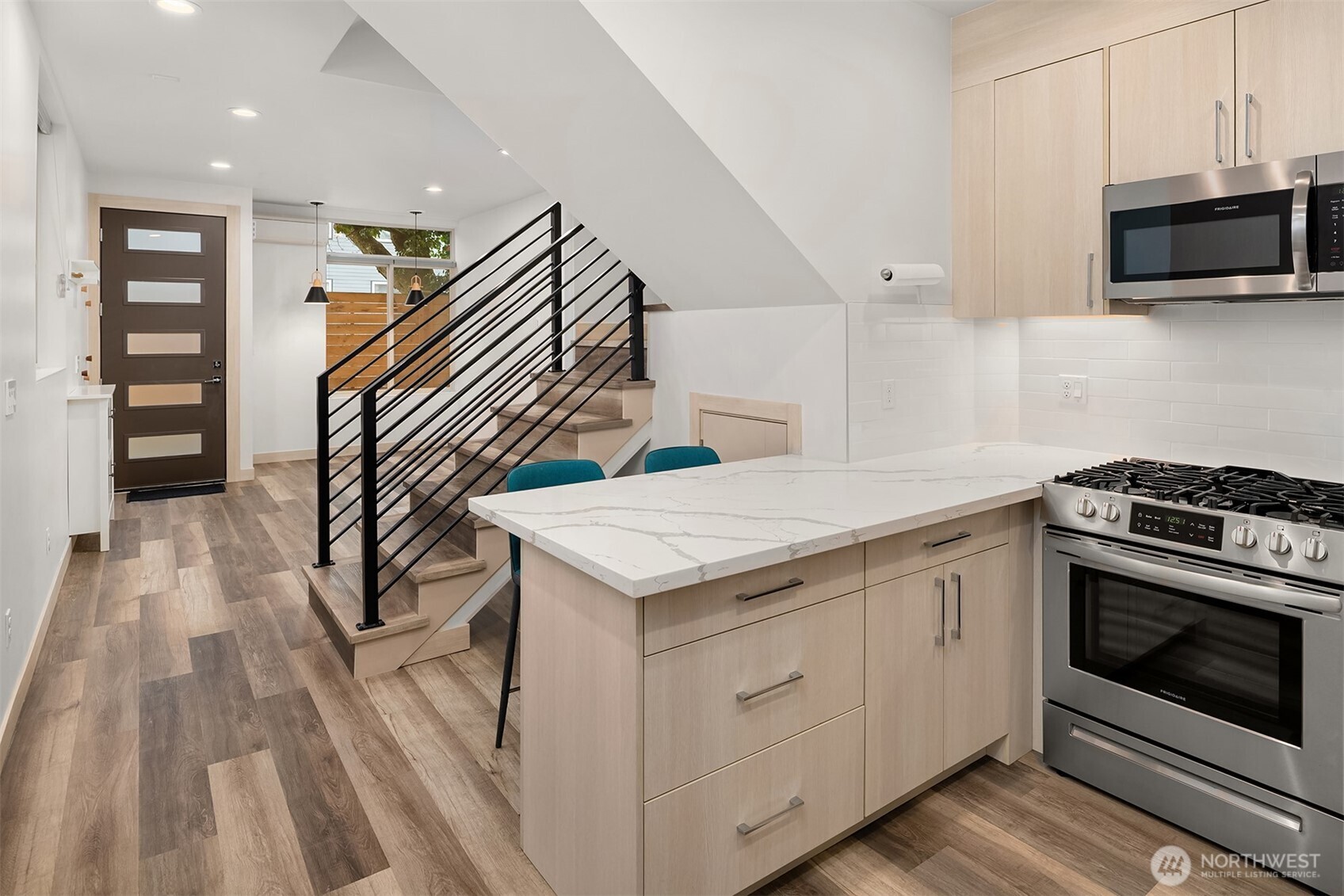 5616 California Avenue Southwest, Unit C Seattle, WA 98136 - Photo 11 of 36 a kitchen with stainless steel appliances granite countertop a stove and a microwave