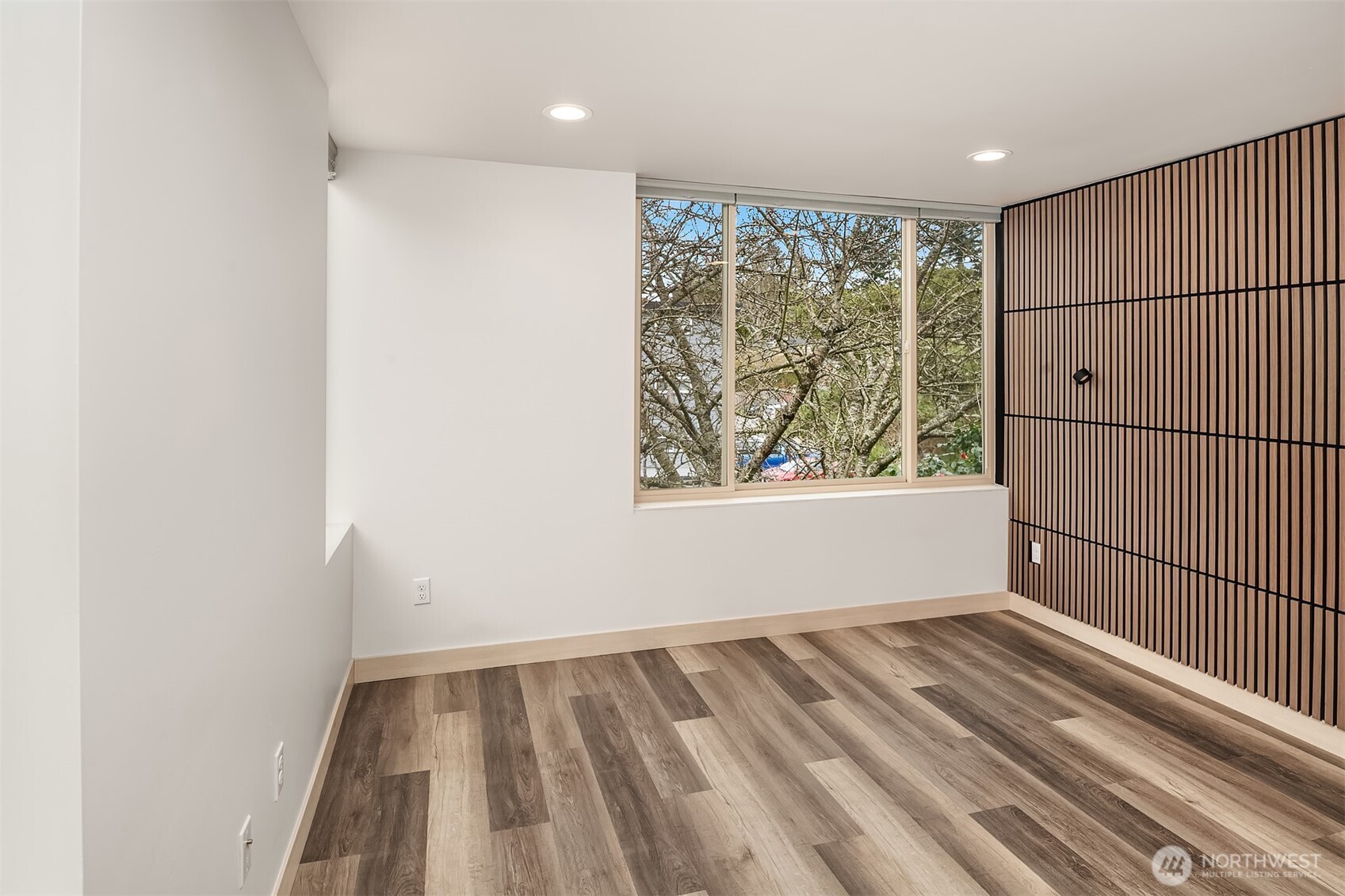 5616 California Avenue Southwest, Unit C Seattle, WA 98136 - Photo 23 of 36 an empty room with wooden floor and windows