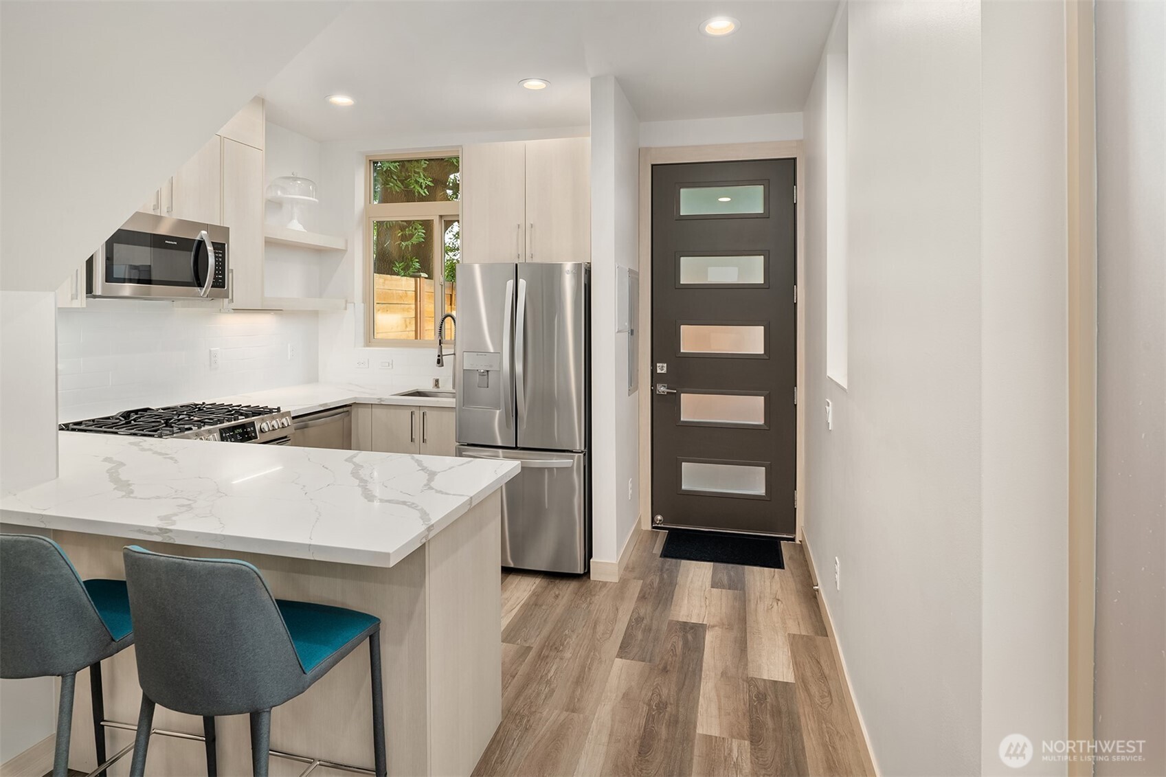 5616 California Avenue Southwest, Unit C Seattle, WA 98136 - Photo 7 of 36 a kitchen with stainless steel appliances a refrigerator and a stove