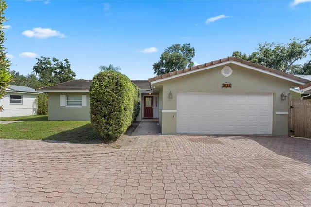 a view of a house with a yard and garage