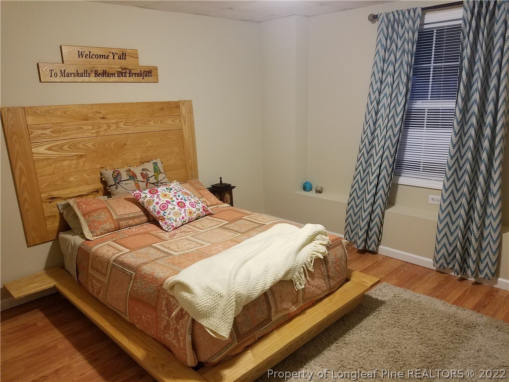 281 Stubby Oaks Road Aberdeen, NC 28315 - Photo 12 of 15 a bed sitting in a bedroom next to a window