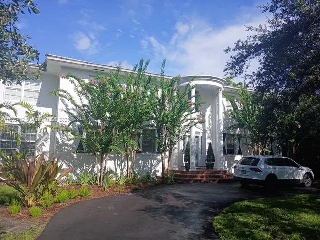 a front view of a house with garden