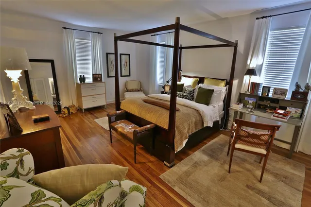 a bedroom with a bed window and dresser