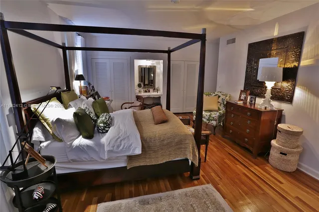 a bedroom with a bed furniture and a chandelier