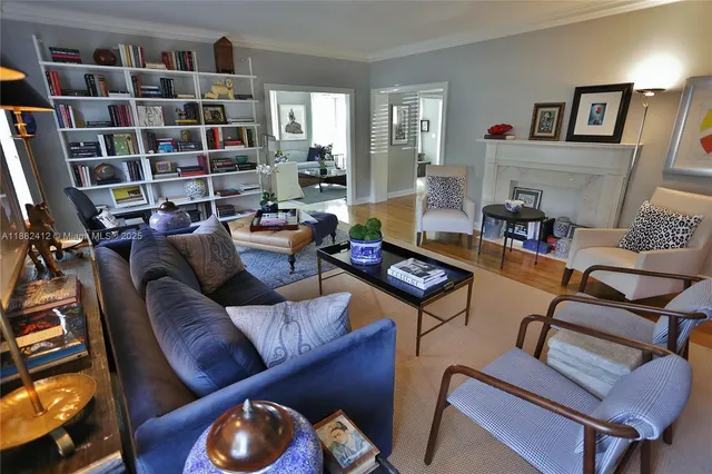 a living room with furniture and a book shelf