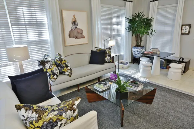a living room with furniture flowerpot and wooden floor