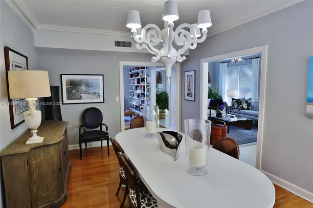 a dining room with furniture a chandelier and window
