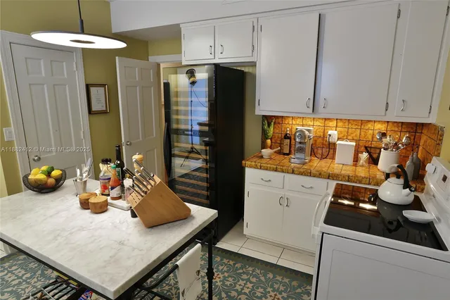 a kitchen with stainless steel appliances a stove a refrigerator and cabinets