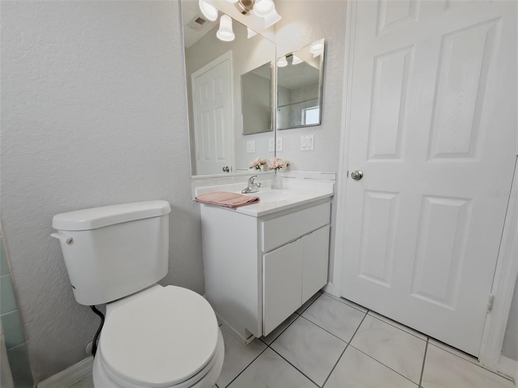2202 Godfrey Avenue Spring Hill, FL 34609 - Photo 27 of 36 a bathroom with a toilet sink and mirror