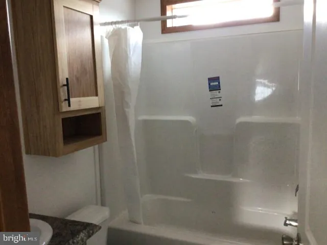 a bathroom with a shower and a toilet