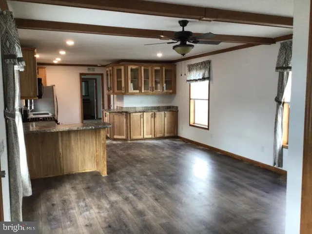 a view of kitchen with cabinets and wooden floor
