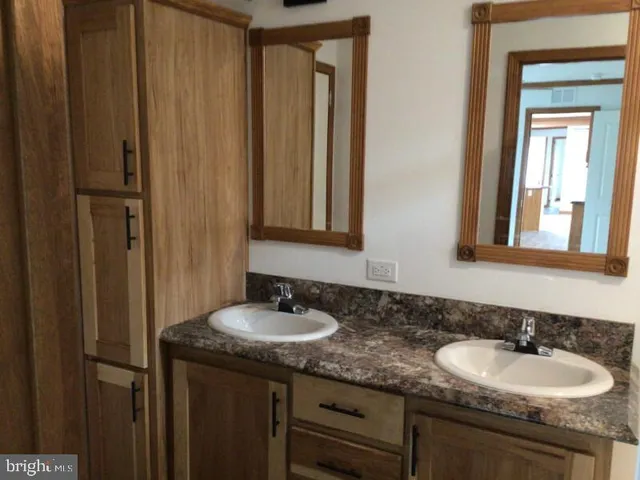 a bathroom with 2 sink and a mirror