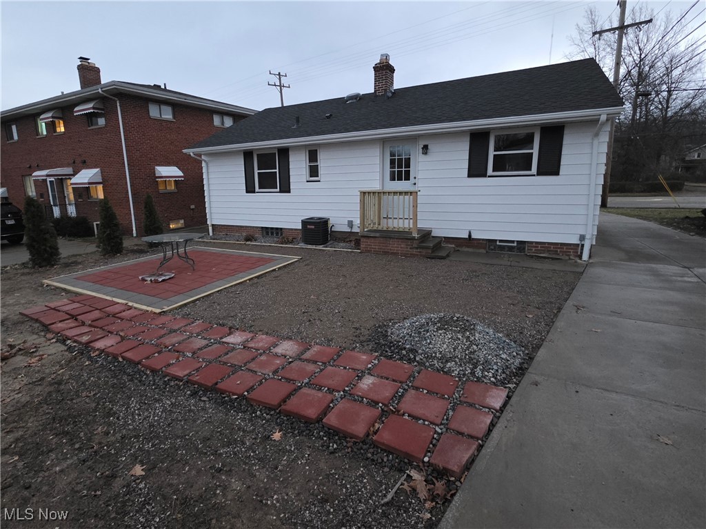 6660 State Road Parma, OH 44134 - Photo 23 of 25 Rear view of house with a chimney, a patio, and a shingled roof
