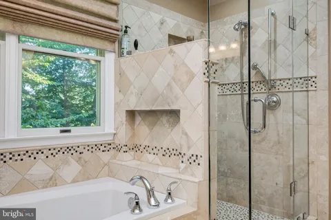 a bathroom with a bathtub and shower