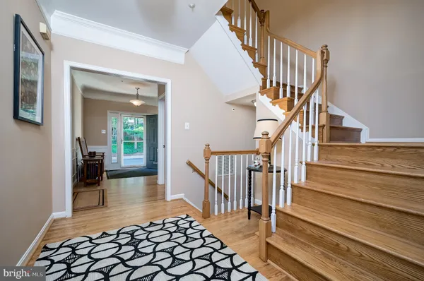 a view of entryway and hall with wooden floor