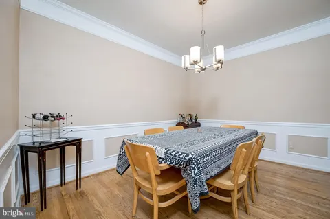 a view of a dining room with furniture wooden floor and chandelier
