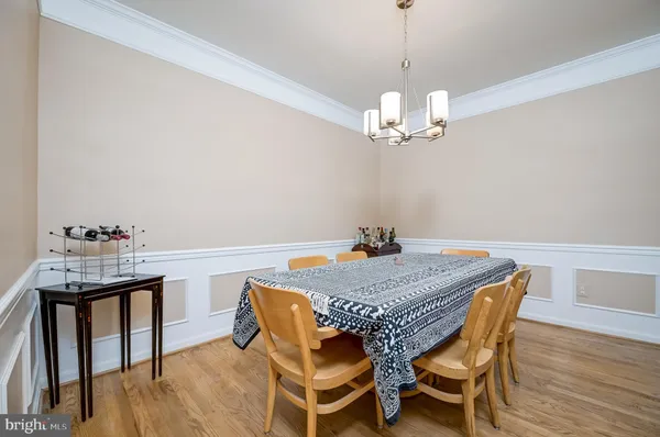 a view of a dining room with furniture wooden floor and chandelier
