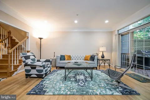 a living room with furniture and a rug