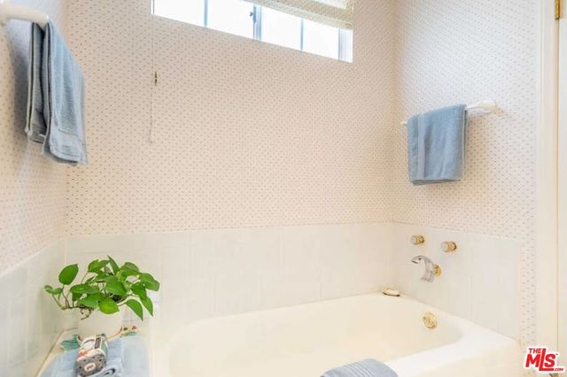 a view of a house with a yard and potted plants
